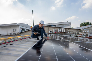 Engineer service check installation solar cell on the roof of factory. Silhouette technician inspection and repair solar cell on the roof of factory. Technology solar energy renewable.