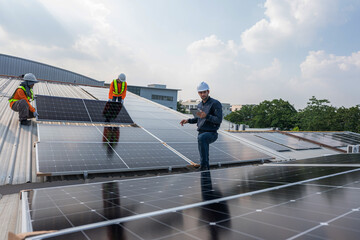 Engineer service check installation solar cell on the roof of factory. Silhouette technician...