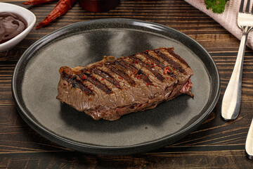 Grilled beef striploin steak with sauce