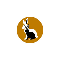 the logo of two rabbits in a dark yellow circle