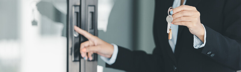 Woman hand hold key buy home model business concept involves sell financial management investment bank loan ownership income economy finance investments purchasing apartment blur background estate