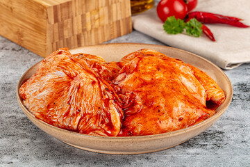 Raw chicken marinated thighs with skin