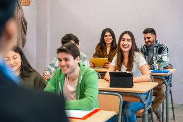 University students following a lesson and using digital tablets