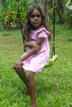 4 year old aboriginal girl holding sore elbow