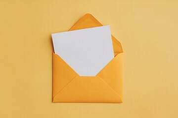 Yellow open envelope on a yellow background with a blank note inside