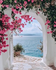 Fototapeta premium A whitewashed archway with pink flowers overlooks the Aegean Sea