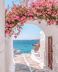 Fototapeta premium A whitewashed archway with pink flowers overlooks the Aegean Sea