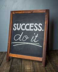 A wooden signboard displays the motivational phrase "SUCCESS. do it" in chalk on a dark background, emphasizing action and achievement.