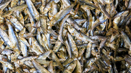 close up view of dried salty fish pile in asian market