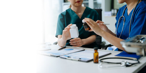 Doctors and nurses collaborate on medical treatment and prescription plans, analyzing data