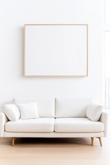 Minimalist living room with a white couch beneath a blank picture frame on a white wall