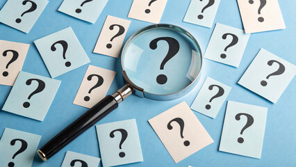 Exploring the unknown: A magnifying glass focuses on a question mark, symbolizing the quest for clarity and understanding
