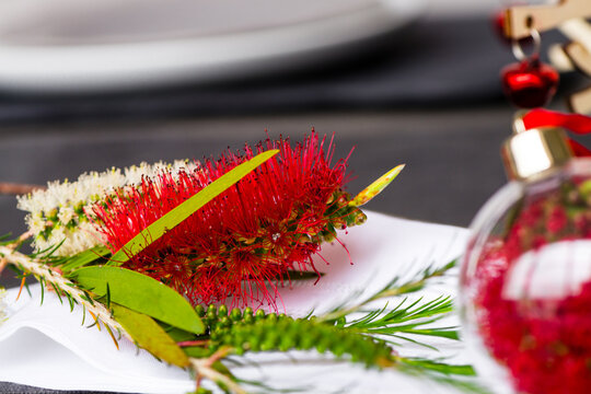Australian christmas theme table with red native bottlebrush flower, focus on the flower