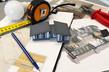 Architects house model with measurement tool and blueprints on architect desk. A architects home...