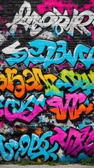 Obraz premium Colorful graffiti artwork on urban brick wall with vibrant blue, pink, orange, and white lettering. Street art background for creative design