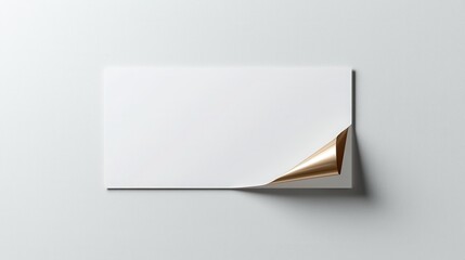 Fototapeta premium Minimalist blank paper with corner curl on a gray background, perfect for design mockups or presentations.