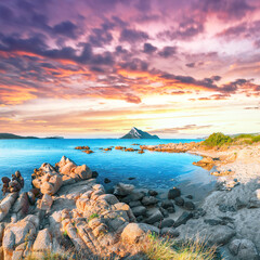 Superb evening scene of Porto Taverna beach with Tavolara mountain on background.