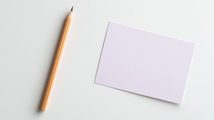 Minimalistic setup with a blank card and pencil on a white background, perfect for design or note-taking concepts.