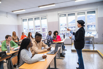 High school teacher explaining lesson to diverse group of students