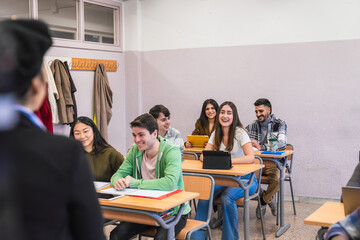 High school students listening to teacher during class lesson