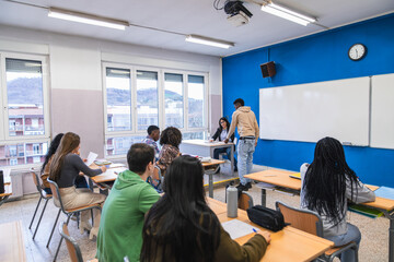 Fototapeta premium High school students working in groups during class