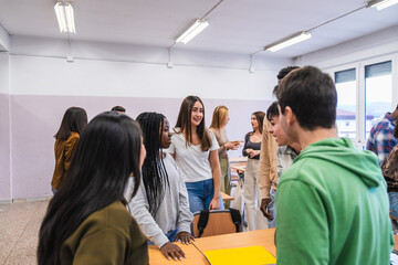 High school students interacting during break time in classroom