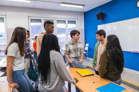 High school students collaborating on a project in modern classroom