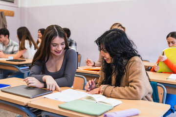 High school students collaborating on project in classroom