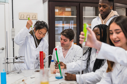 High school students conducting experiments in chemistry lab - Powered by Adobe