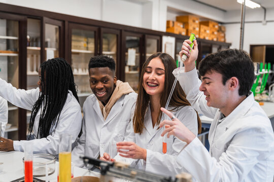 High school students conducting experiments in chemistry lab