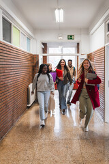 High school students walking and running in school corridor
