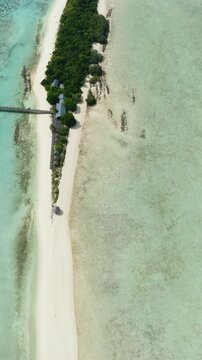Aerial drone of sandy beach and coral reef. Sandbar and atoll. Timba Timba islet. Tun Sakaran Marine Park. Borneo, Sabah, Malaysia. Vertical video.