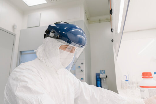 Researcher wearing safety helmet working in laboratory