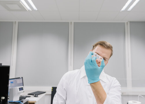 Scientist analyzing a specimen in laboratory