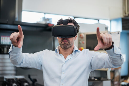 Businessman using VR glasses in a factory