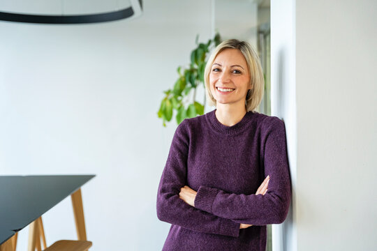 Portrait of a smiling woman in a modern office setting