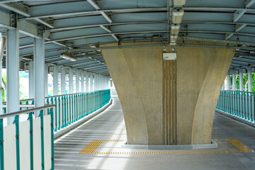 Pedestrian overpass path under the road junction at the base of the bridge support