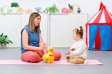 Nonverbal child with Down syndrome learning baby sign language with the help of a speech therapist....