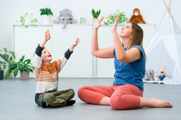 Baby Sign Language. Nonverbal child learning to sign with the help of a speech therapist. Child therapy, neurodiversity, learning difficulty, developmental disability.
