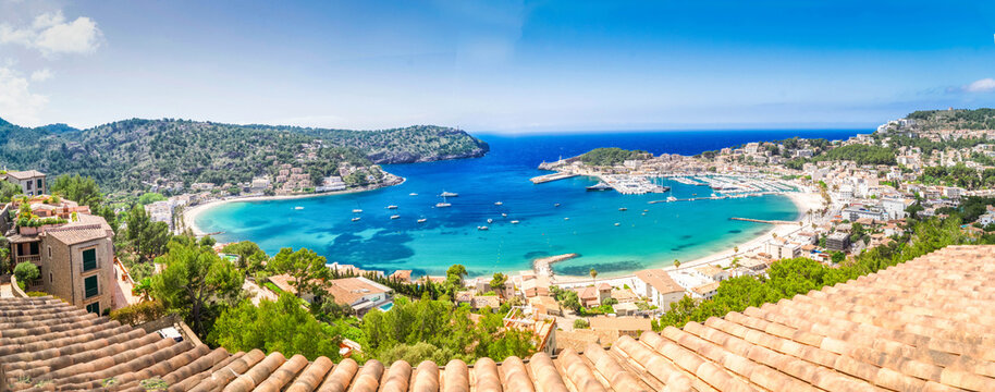 view of Port Soller harbour with house roofs, Mallorca at summer, wide panorama