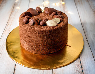 chocolate cake round with nuts chocolate truffle cake on golden cake board plate 