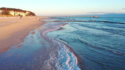 sunrise light on the aerial view over the beach of Heringsdorf island Usedom on Baltic Sea, frozen beach in winter season