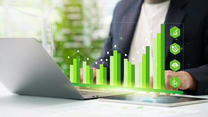 Businessman analyze sustainability investment with icons and Green chart. Concept of ESG, Green...