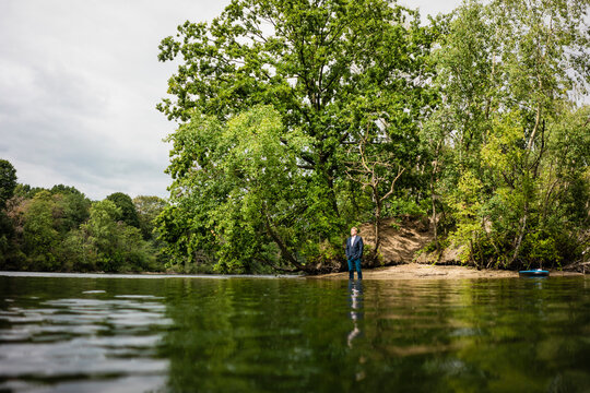 Businessman at a lonely island in a lake