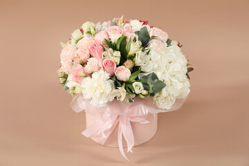 Bouquet of beautiful flowers on beige background