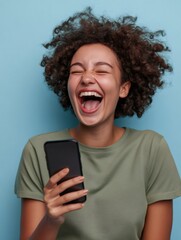 Overjoyed ethnic woman holding smartphone and laughing out loud