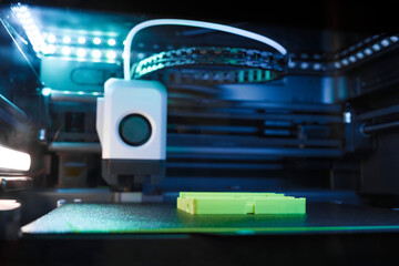 3D Printer Is Actively Creating a Bright Green Object in Contemporary Design Studio. The Device...