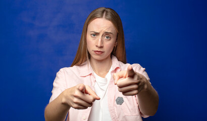 pointing forward at camera with both fingers and angry expression, telling you to do your duty
