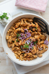 Tasty chopped and pan fried chicken breast with delicious greek spices, gyros style served ready to eat in frying pan.