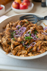 Tasty chopped and pan fried chicken breast with delicious greek spices, gyros style served ready to eat in frying pan.